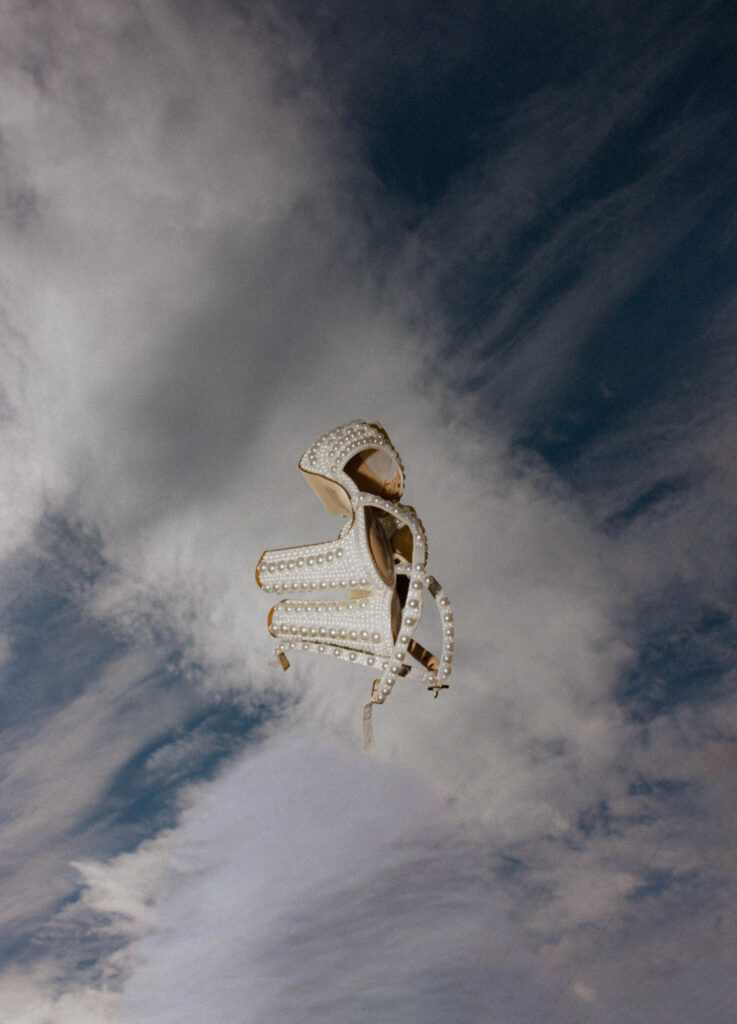 editorial shot of wedding shoes in the sky
